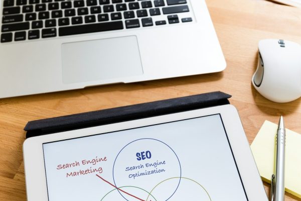 Business working desk with tablet showing search engine marketing concept